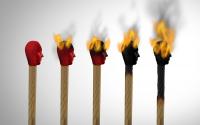 Set against a white background are five matches, with red human heads in the center of the picture. From left to right, they progressively burn. The first match has a red top face with brown wood, and the last match is completely burned black.